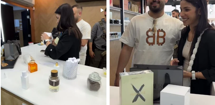 זוג לקוחות מחייכים עם קופסת בושם